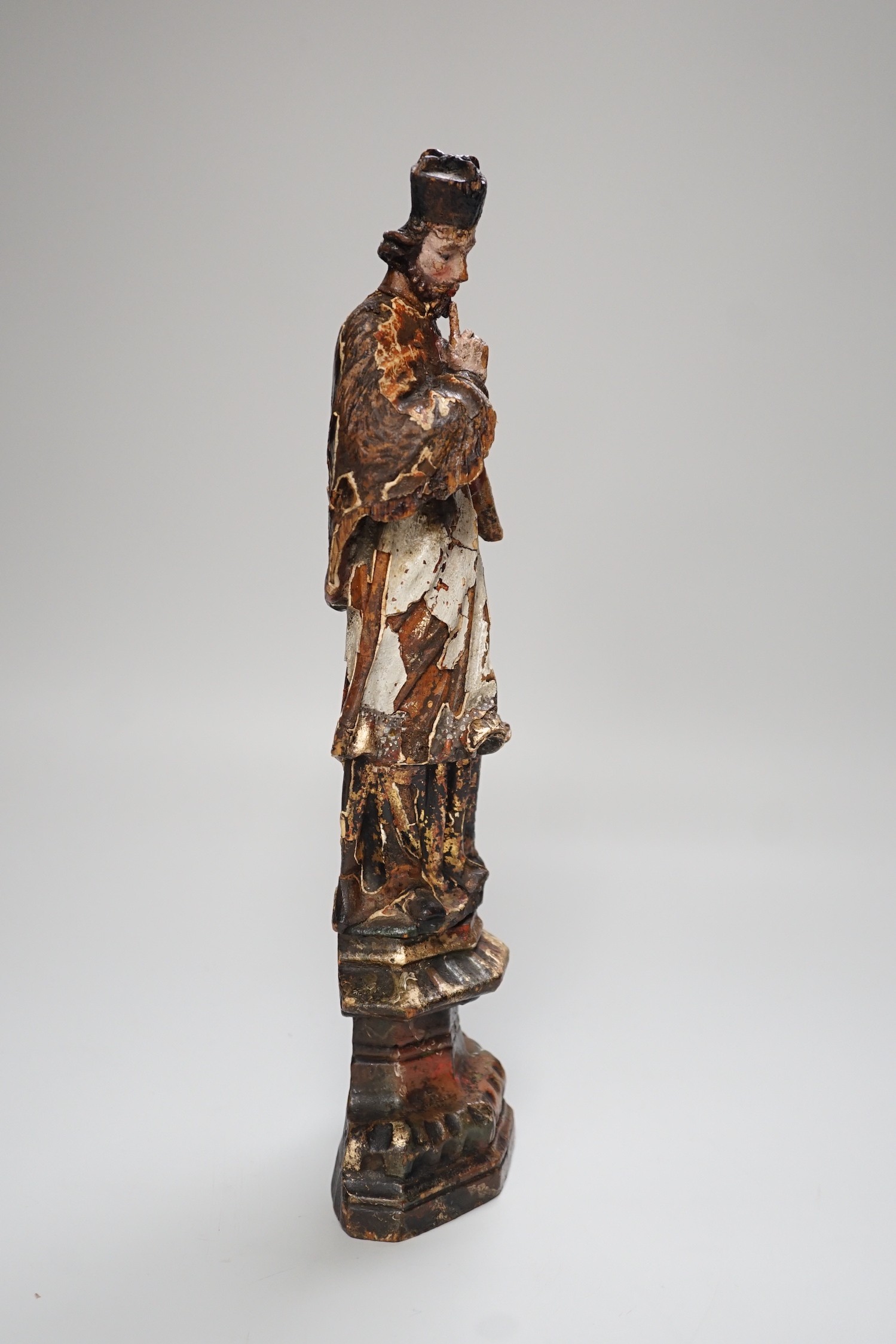 An 18th/19th century Continental carved wooden polychrome figure of saint, 33cms high